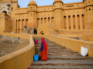 Woman sweeping the stairs of Amber Fort in Jaipur, India 