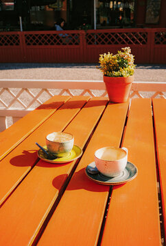 Two empty cups after cappuccino on terrace of cafe on summer day 