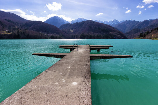 Wooden pier on turquoise mountain lake