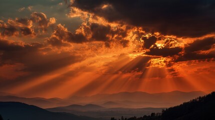Majestic sunset over mountain landscape with dramatic clouds and sun rays.