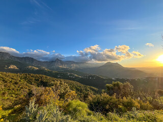 Vibrant sunset over the majestic mountains and lush green valleys of the Kabylie region in Algeria.