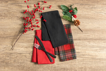 Festive table setting for Christmas, Checkered napkin set, dinner on wooden background, top view