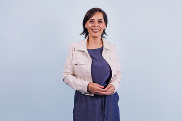 portrait of adult latina woman smiling on blue background in Mexico Latin America, or hispanic senior brunette female 