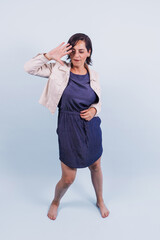 portrait of adult latina woman smiling on blue background in Mexico Latin America, or hispanic senior brunette female 