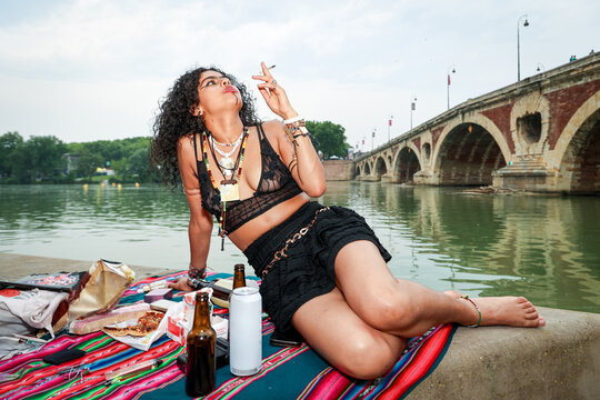 Woman drinking, smoking and Enjoying by the River