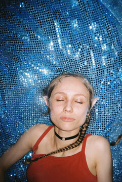 Dreamy female Portrait on Sparkling Blue Fabric 