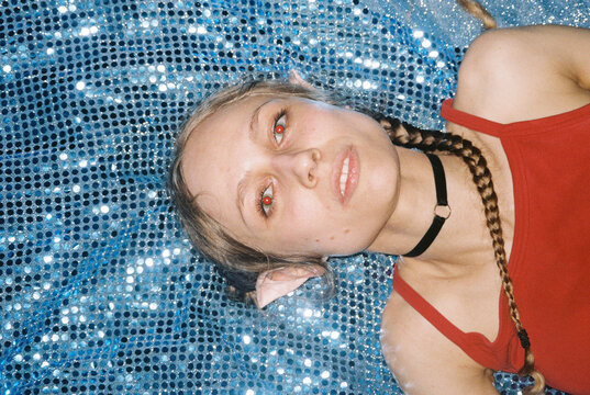 Dreamy female Portrait on Sparkling Blue Fabric 