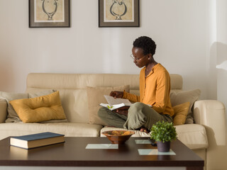 Smart woman reading academic study in book 