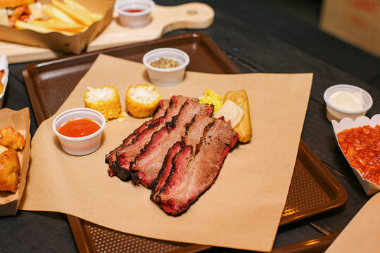 Delicious BBQ Feast With Fries, Sides, and Desserts at a restaurant