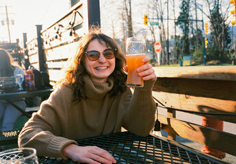 Woman having beer on sunny afternoon on weekends 