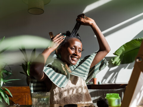 Woman enjoying hair care routine at home 