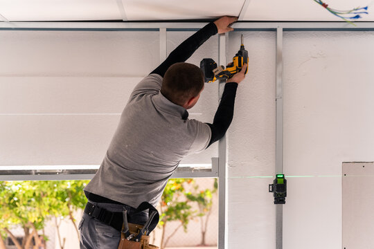 Worker assembling drywall framing 