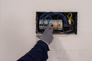 Electrician checking circuit breakers panel 