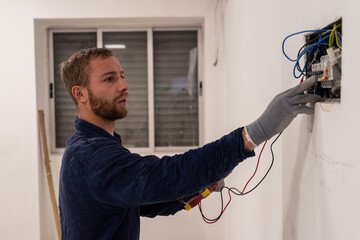 Focused electrician checking wiring