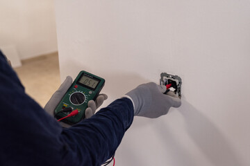 Electrician using multimeter
