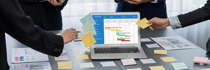Project planning software for brisk business project management on the computer screen showing timeline chart of the team project