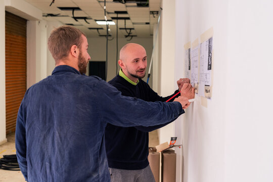 Men discussing project at construction site