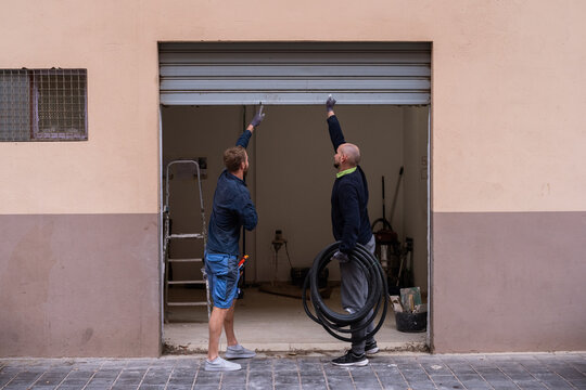 Workers opening gates to construction site