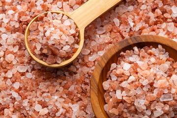 Himalayan pink salt crystals in a spoon and bowl