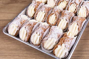 A bakery tray of creamy filled Italian style ricotta cannoli