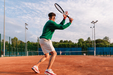 Tennis player prepares to serve