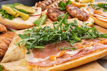 An Italian charcuterie table with prepared deli meats and breads