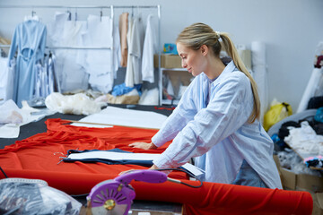 Artisan fabricator skilled in measuring and draping within boutique environment