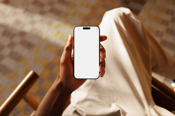 Smartphone Mockup with White Screen in Relaxed on Lounge Chair