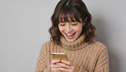 Young woman with a joyful expression looking at her smartphone screen