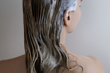 Washing Hair with Shampoo Foam on Wet Blonde Hair