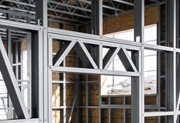 Detailed view of cold-formed steel framing structure, braced opening header, light gauge metal construction.