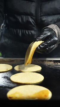 Vertical slow-motion close-up of tortillas heating on a grill, steam rising to evoke the rhythm and authenticity of street food taco preparation - Taco Stand Series - Food vendor