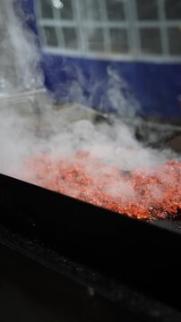 Sizzling hot al pastor meat cooks on a grill in slow motion. Steam rises, releasing rich aromas and flavors, capturing the street food experience of outdoor cooking Mexican tacos - Taco Stand Series 