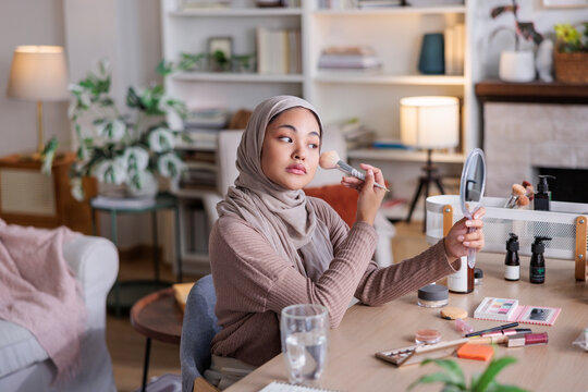 Woman in hijab testing makeup
