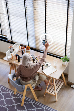 Muslim influencer records makeup tutorial