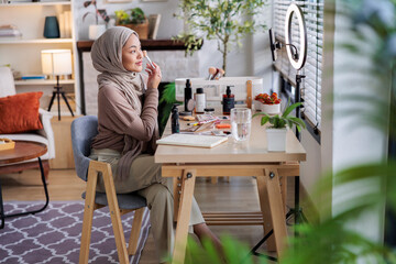Muslim woman testing makeup on live stream