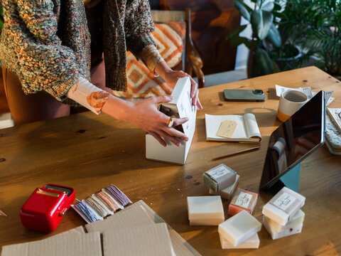 Preparing a Package in a Cozy Workspace During the Day