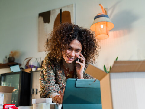 Woman talking to customers via phone 