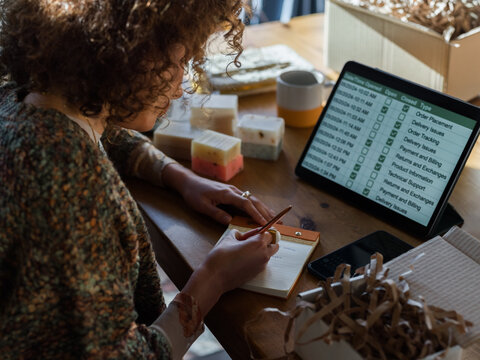 Entrepreneur taking notes while working