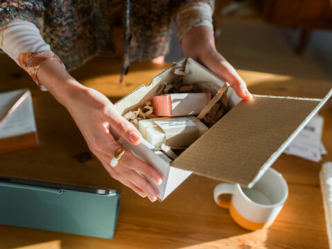 Woman holding box with handmade goods 
