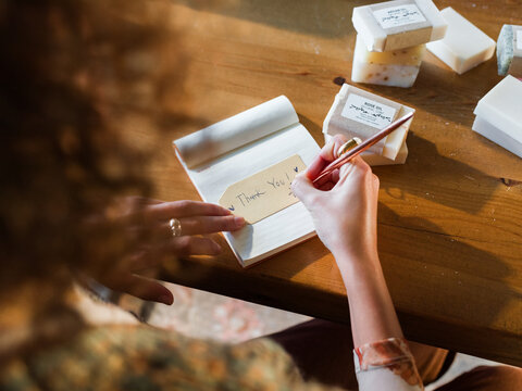 Seller writing greeting to customer 