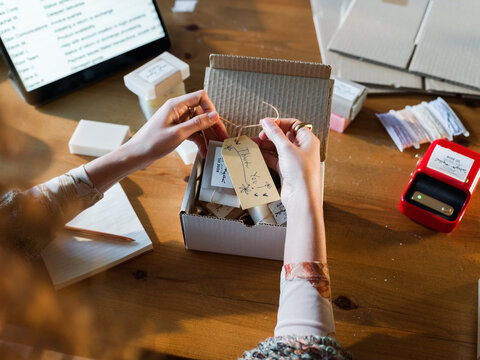 Preparing Handmade Products for Shipment in a Cozy Workspace