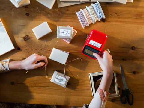 Woman using label printer