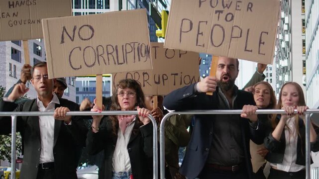 Warring crowd of activists chanting against corruption and political misconduct, holding banners and posters asking to stop corruption, wanting public accountability and democracy. Camera A.