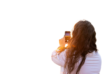 Female engineer photographing wind turbine during golden hour sunset for renewable energy development. PNG background