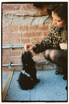 A girl gives her dog a treat 