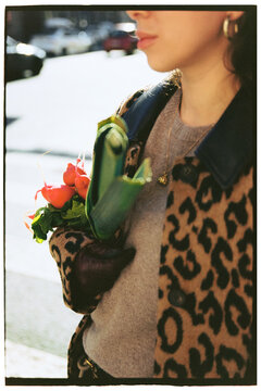 A girl holds vegetable purchases in her hand 