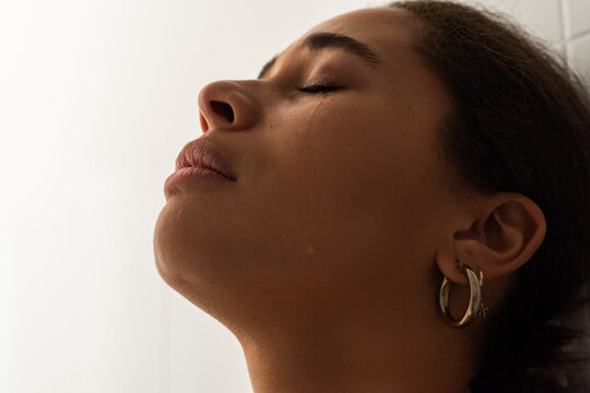 Woman crying with eyes closed