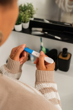 Woman looking at pregnancy test