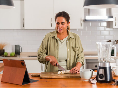 Woman watching recipe on tablet 